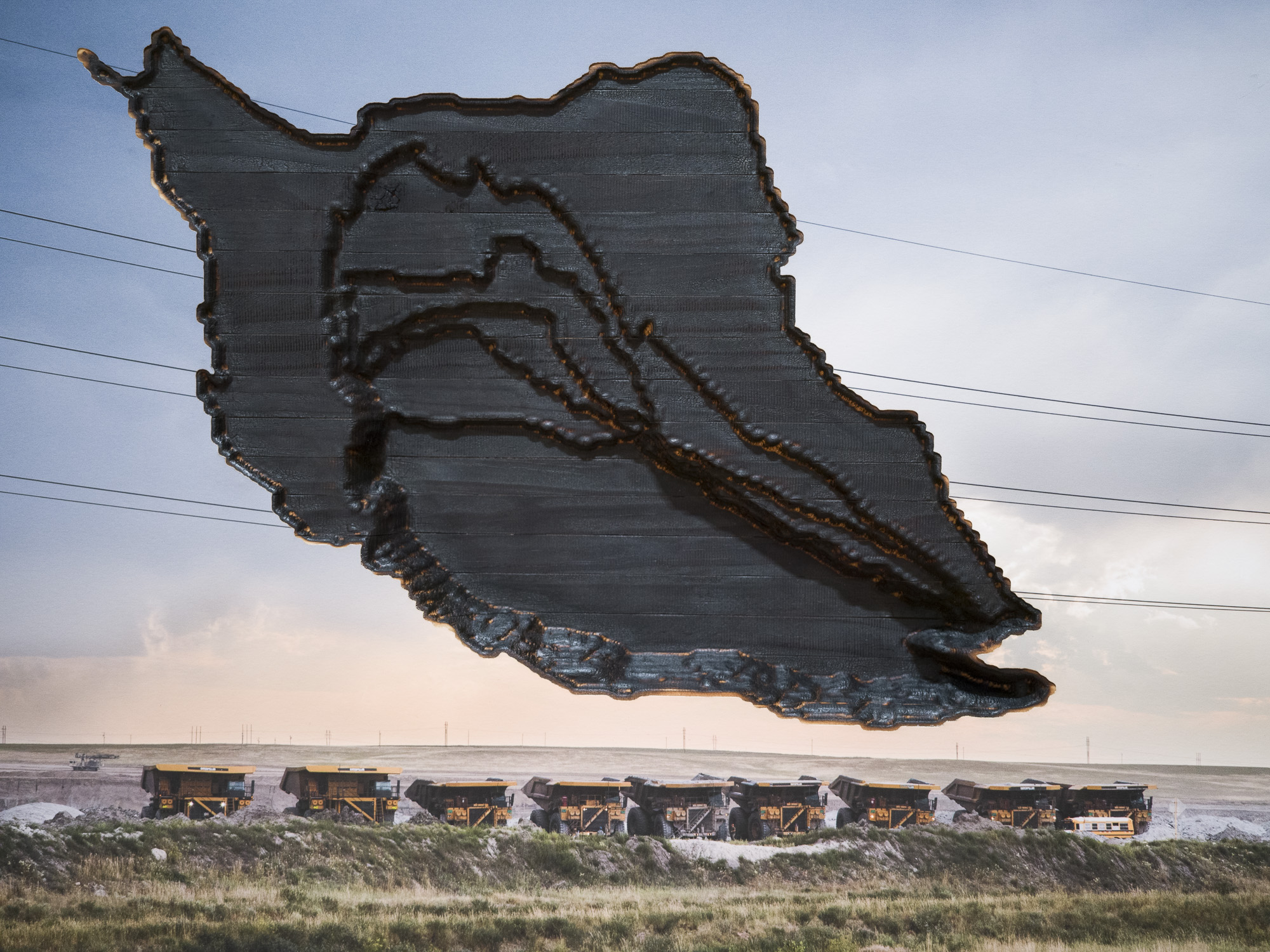 Mining trucks linked up with a topoographical map of glacier recession carved into the sky