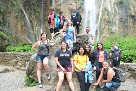 Group of IUPUI students standing in front of a Croatian waterfall